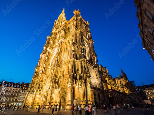 Strasbourg Cathedral illuminated at night (Cathedral of Our Lady of Strasbourg or Cathedrale Notre-Dame de Strasbourg), also known as Strasbourg Minster, Alsace, France wide angle
