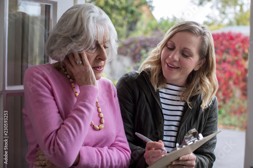 Female Sales Person Trying To Persuade Senior Woman To Purchase Goods Or Services