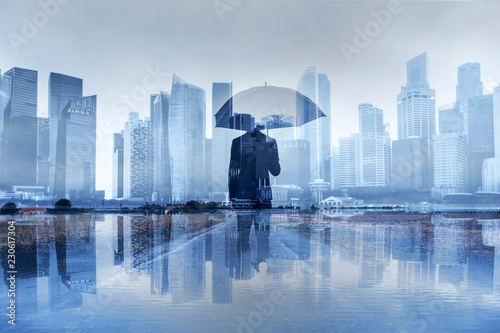 insurance concept, risk in business, businessman with umbrella double exposure