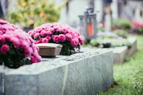 Holy water in iron bowl, cemetery, flowers