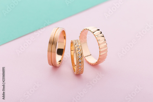 Stylish pink gold rings with different design on pink background