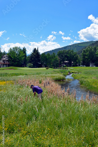 Golfer searching for lost golf ball in Vail COlorado