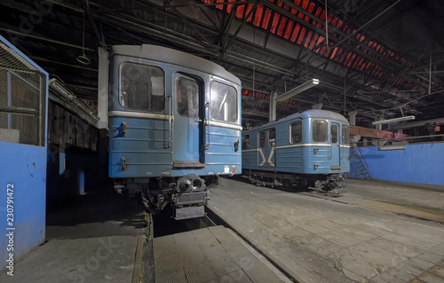 Old blue dust covered metro rail cars. Rolling stock in industrial room