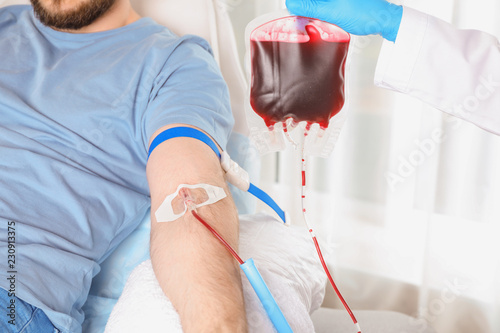 Man donating blood to save someone's life in hospital