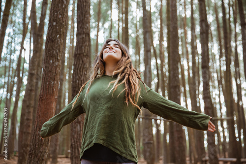 young woman hiker relaxing in the woods