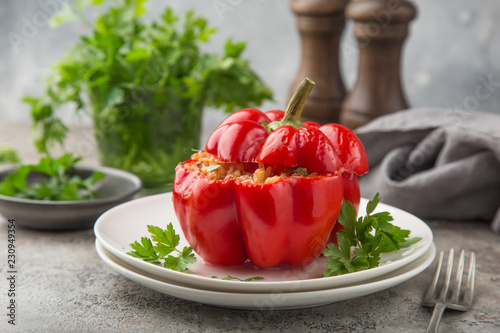 red bell peppers stuffed with meat, rice and vegetables on cast iron pan