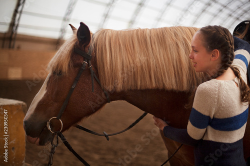 Horse and teen girl - best friends. Learning equestrian