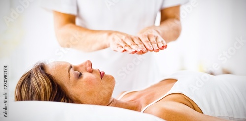 Young woman receiving reiki treatment