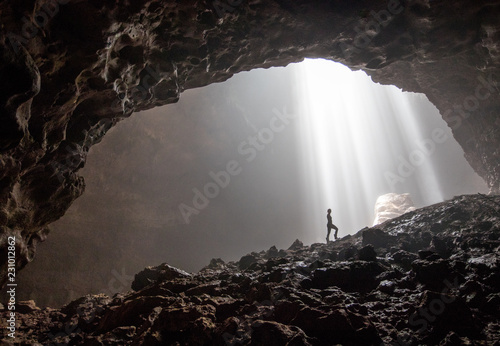 A silhouette inside the beautiful cave Goa Jomblang in East Java, Indonesia