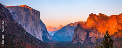 Yosemite National Park Tunnel View overlook at sunset. Front view panorama of popular El Capitan and Half Dome at deep red sunset. Summer american holidays. California, United States.