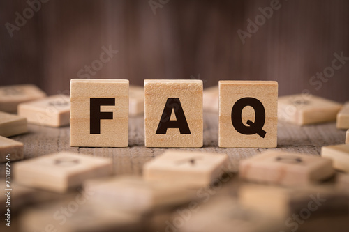 FAQ Sign With Wooden Background