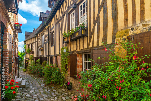 old cozy street with historic half timbered buildings in the the beautiful town of Honfleur, France
