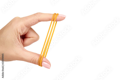 Yellow rubber bands close up with hand isolated on white background, copy space template.