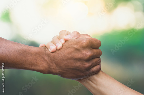 Helping, Rescue, Friendship concept. Hand gestures help in natural background and sunlight.