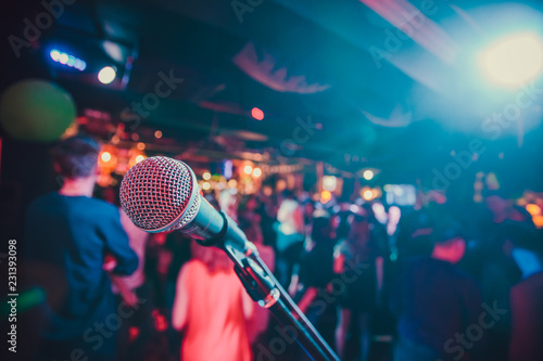 Public performance on stage Microphone on stage against a background of auditorium. Shallow depth of field. Public performance on stage.