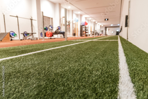 Artificial grass in the sport hall with the gym in background