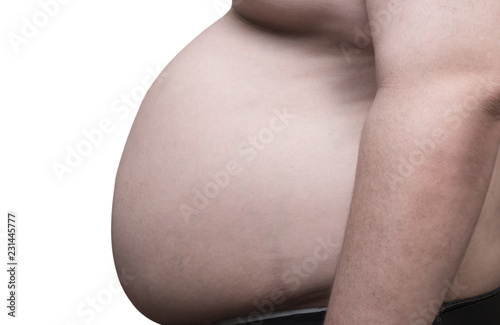 close up side view of overweight obese man and his big belly, isolated in white background. Poor nutrition and increased risk of heart disease.