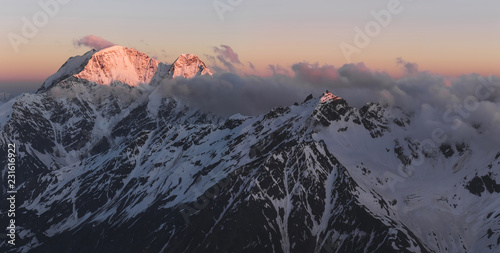 Panoramic view of high mountain peaks in beautiful morning light. Hiking and climbing in Elbrus region