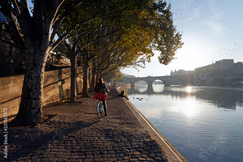 Sunrise and cyclist on the seine river quay in Paris
