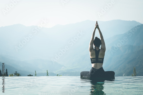 Beautiful Attractive Asian woman practice yoga Lotus pose on the pool above the Mountain peak in the morning in front of beautiful nature views in SAPA vietnam,Feel so comfortable and relax in holiday