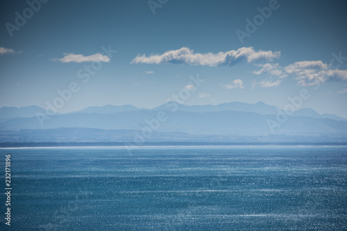 Coastal views of Taylors Mistake, Christchurch, New Zealand on a bright sunny day with blue sea