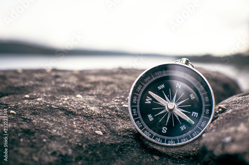 compass on rock in the nature, color vintage style