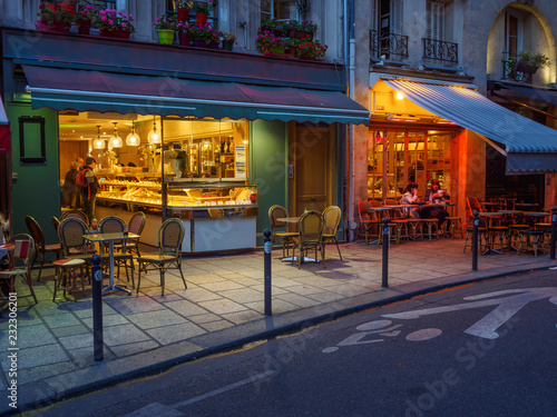 Cozy street with tables of cafe in Paris, France