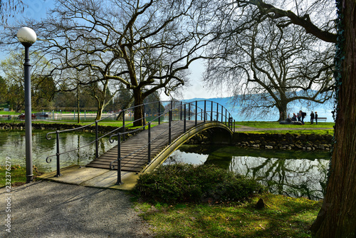 View of the arch bridge in Villette-Park on the shore of Lake Zug on a spring sunny day. Town of Cham, canton of Zug, Switzerland, Europe.