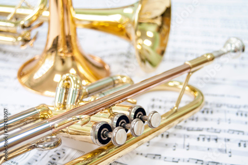 Still life. Three golden trumpets. Two lie on the notes and one trumpet stands. Brass Trio.