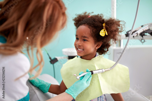Cute kid show her teeth to dental assistant