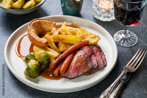 Roast dinner with beef, carrots, brussel sprouts and yorkshire pudding