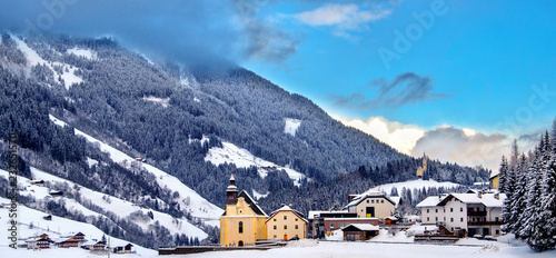 panoramic overview church snowy valley beautiful winter sunny day Trentino Alto Adige Italy