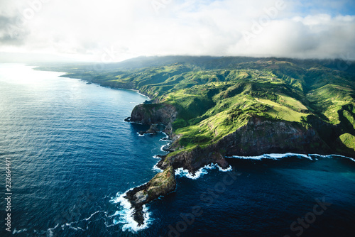 Beautiful Aerial View of Tropical Island Paradise Nature Scene of Maui Hawaii On Clear Sunny Day with Vibrant Blue Ocean Water and Waves and Lush Green Mountain Scenic Landscape 