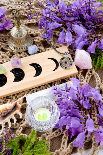 Witch Pagan Altar decorations with Moon Phases, crystals, flowers and pentacle