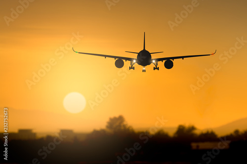 Silhouette airplane takeoff at sunset