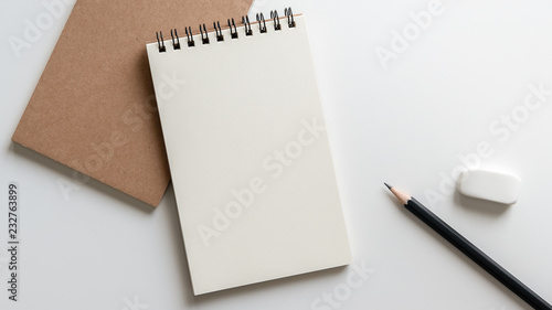 open blank spiral notebook with pencil and eraser on white background.Empty Space for your text.