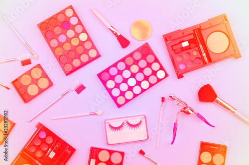 Cosmetics set for women isolated on sweet color paper background,pastel color filter style.