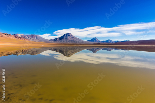 Amazing volcanoes reflections above the Lejia Lagoon waters at 4,500 masl inside the Atacama Desert just an amazing adventure and experience in this awe travel destination to this remote location 