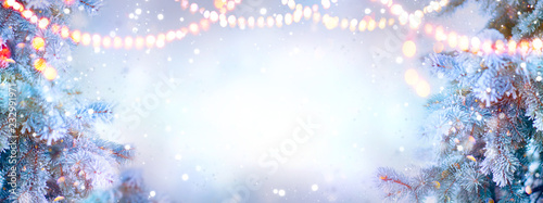 Christmas background. Xmas tree with snow decorated with garland lights, holiday festive backdround. Widescreen frame backdrop. New year Winter art design, Christmas scene