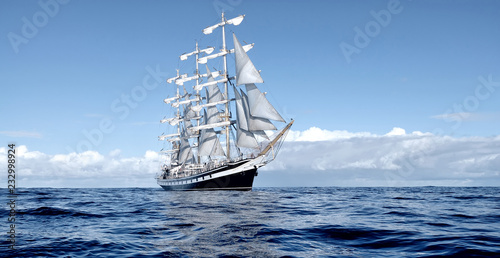 Sailing ship under white sails at the regatta