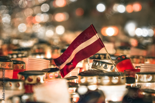 Latvian patriots lighting candles as a tribute to fallen freedom fighters. Hundreds of lighten up candles creating cosy atmosphere. Lāčplēša diena - day of independence of Latvia. 