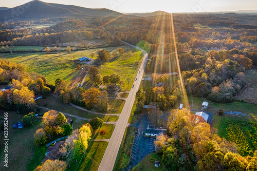 Aerial shot of backlit road in Georgia Mountains during the sunset in the Fall