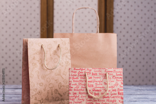 Close up kraft paper shopping bags with handles. Gift paper bags. Holiday shopping concept.