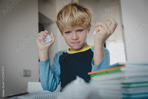 little boy tired stressed of doing homework, bored, agressive