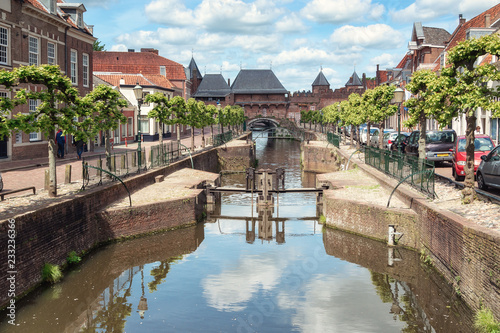 The canal Eem with in the background the medieval gate The Koppelpoort in the Dutch city of Amersfoort