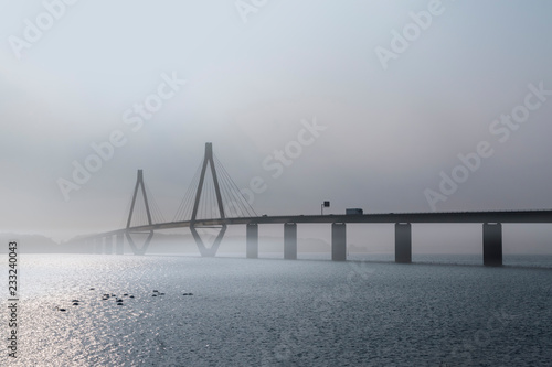 faro bridge in foggy weather, the highway bridge over the Storstroem in denmark connects the islands and is a part of the vogelfluglinie (bird flight line)