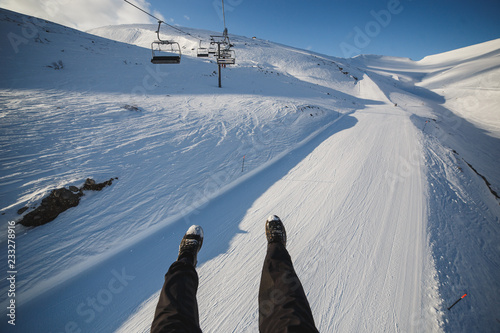 Closeup of legs, shot from ski lift