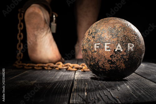 Fear is ball on the leg. Concept of fear.