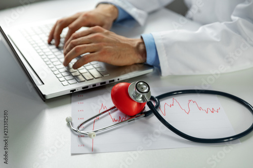 cardiology - doctor cardiologist working on laptop computer in office