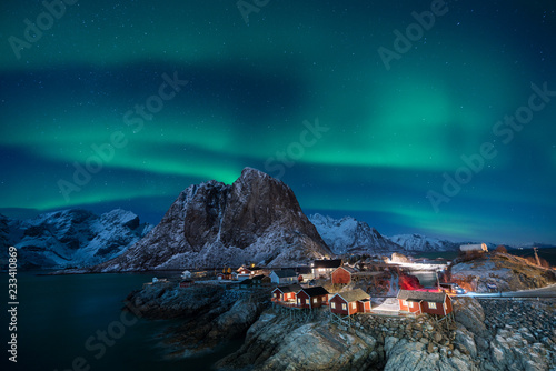 Fisherman village with Aurora in the background travel concept world explore northern light / Lofoten Norway